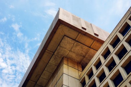 brown concrete building under blue sky during daytime photo