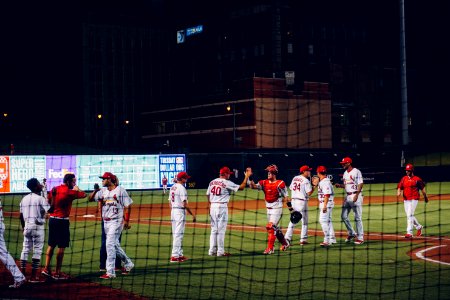 group of men playing soccer on field during nighttime photo