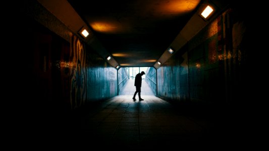 silhouette of a man inside subway
