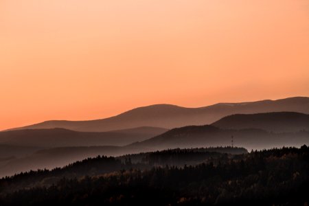 silhouette of mountain during orange sky