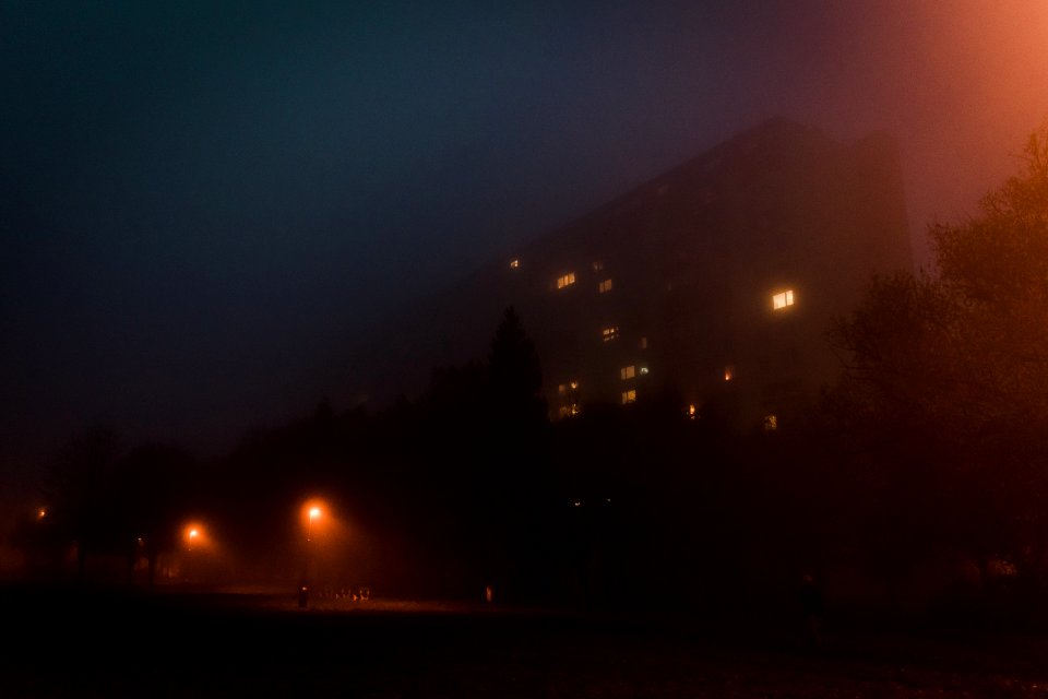 A large building on a foggy night.