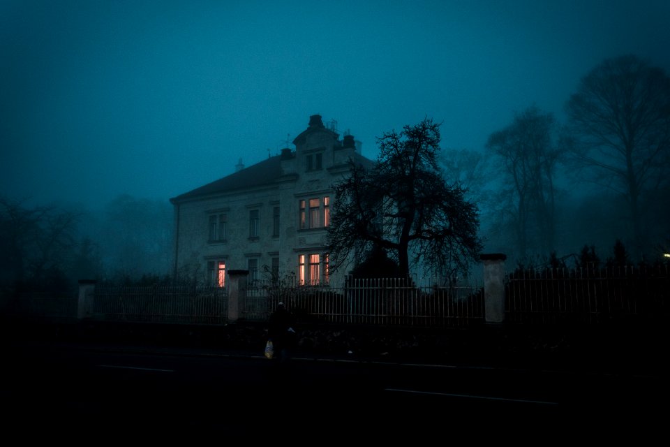 person walking towards house