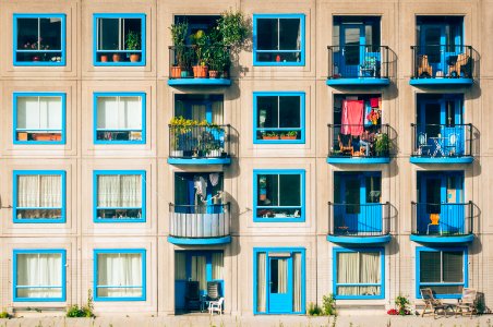 white and blue concrete 4-storey building