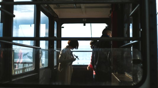 woman and man inside cable car photo