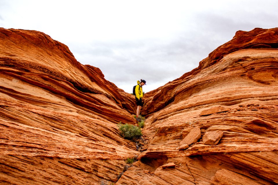 person in between rock formation during daytime