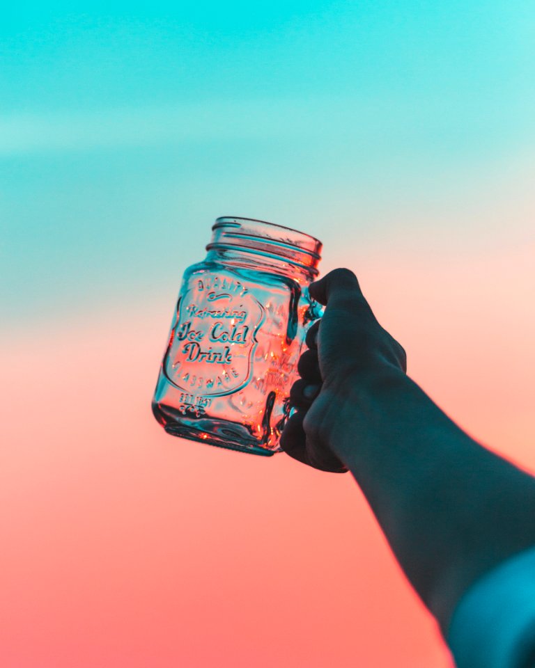 closeup photo of person's holding jar