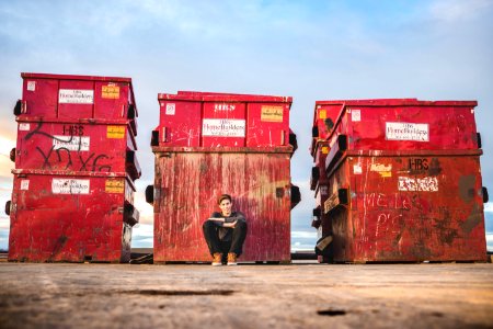 boy leaning while sitting at box