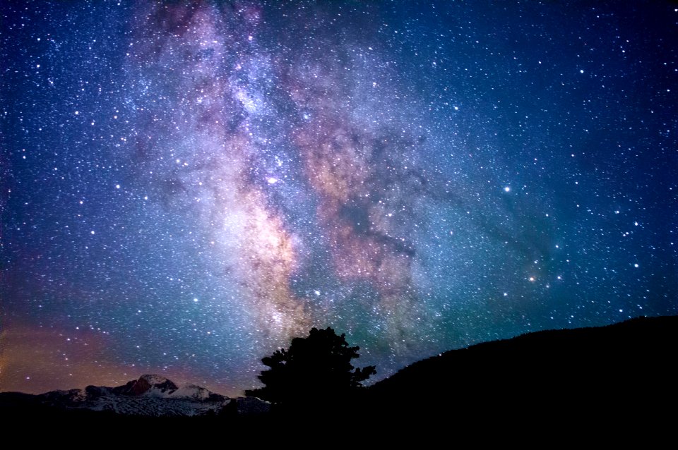 silhouette of trees and mountain under blue sky at nighttime