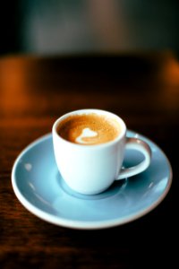 selective focus photography of latte in teacup photo