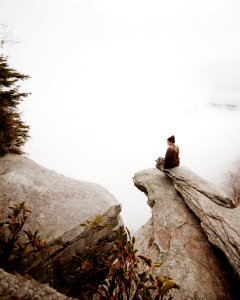 woman sitting on brown rock photo