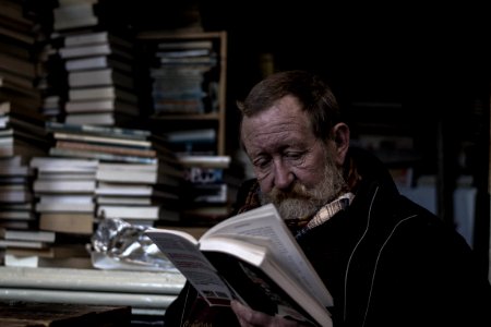 man reading a books photo