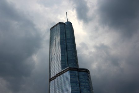 low angle photography of gray high-rise building under cloudy sky photo