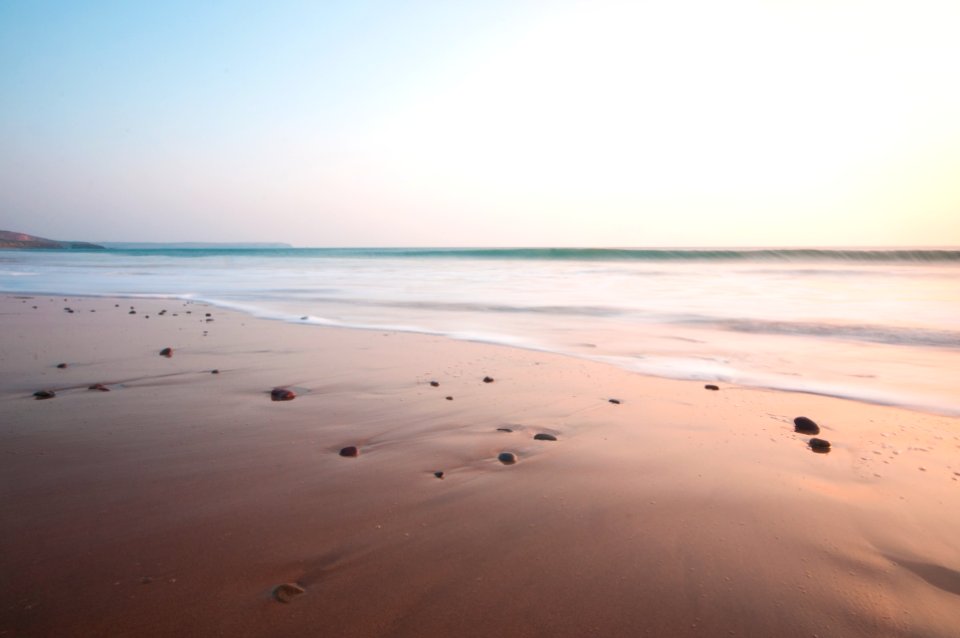 photo of seashore under gray sky