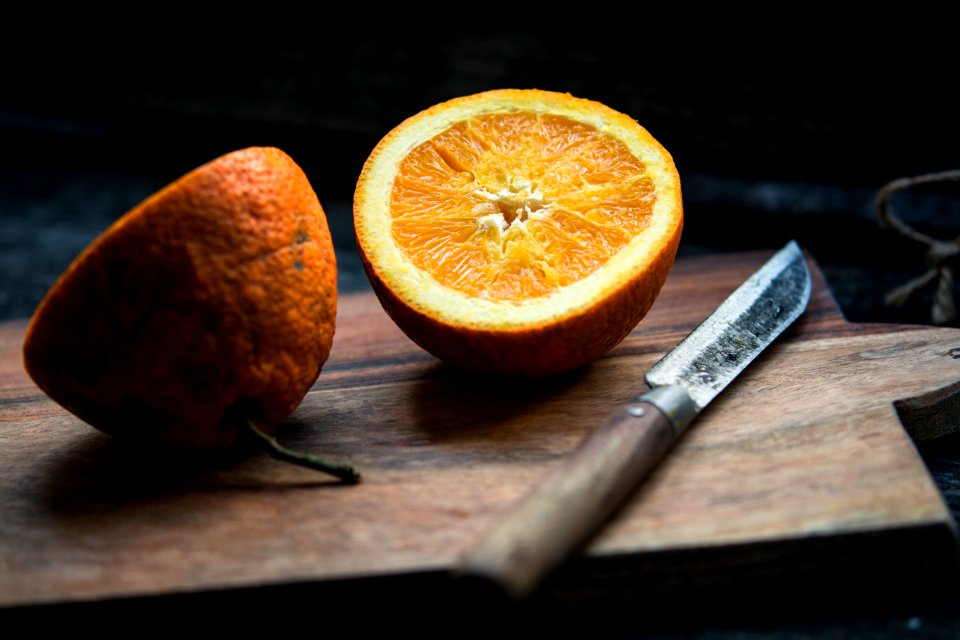 shallow focus photography of sliced lemon beside knife