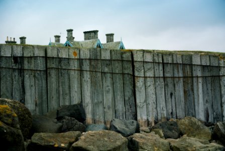 gray wooden fence on gray rocky field during daytime photo