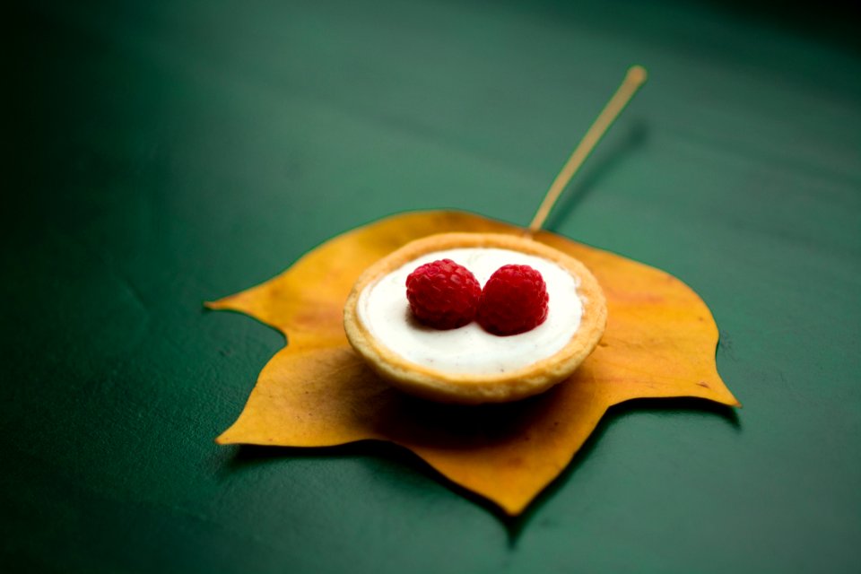 red berry on top of cream in shallow focus photography
