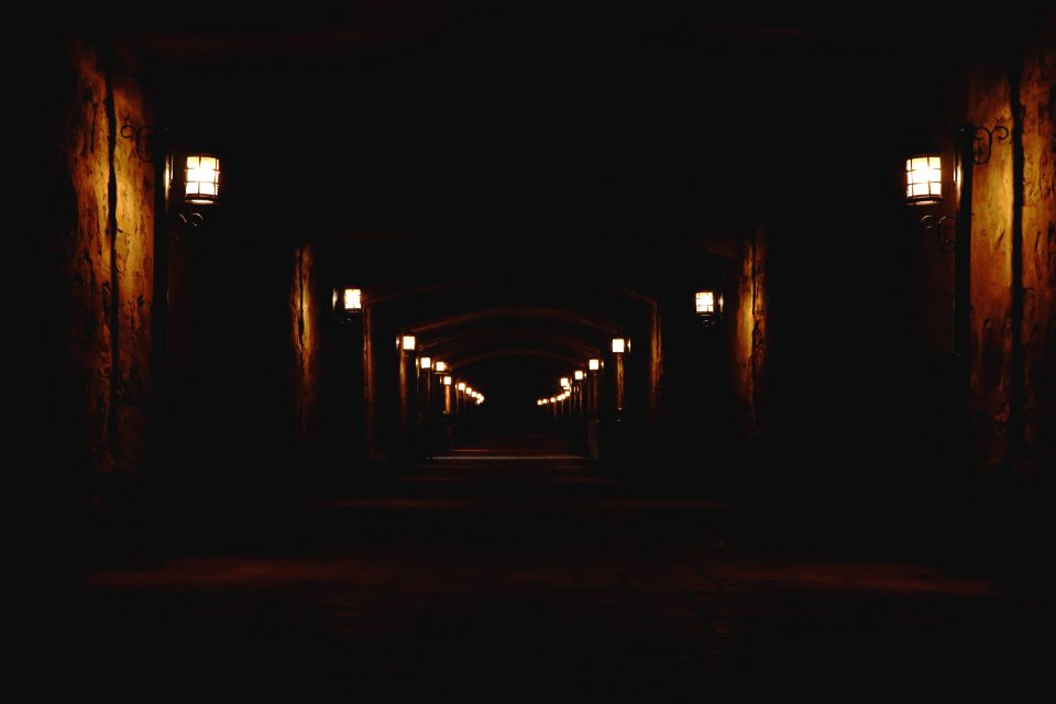 concrete hallway with lighted wall lamps photo