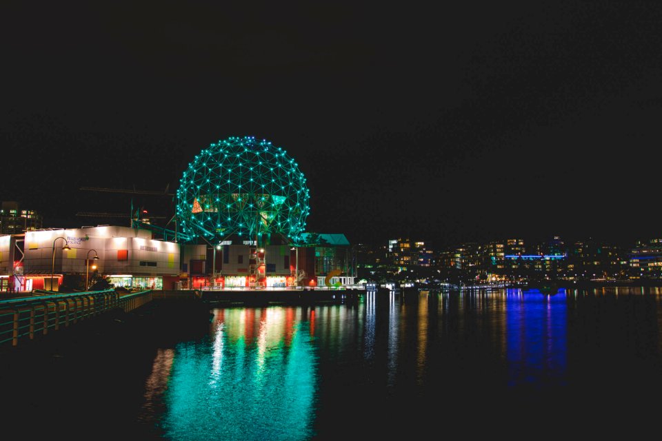 blue and white ball on body of water during night time