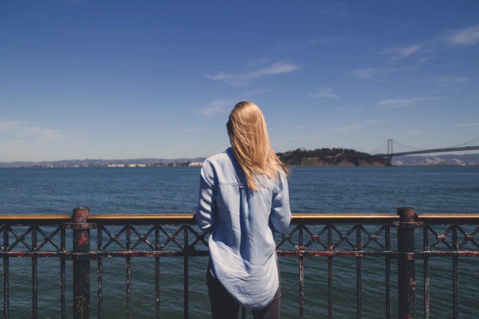 woman standing in front of body of water