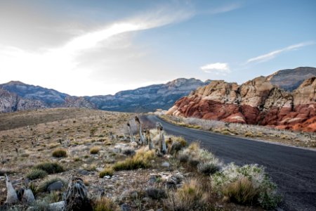 black concrete road surrounded by rocks during daytime