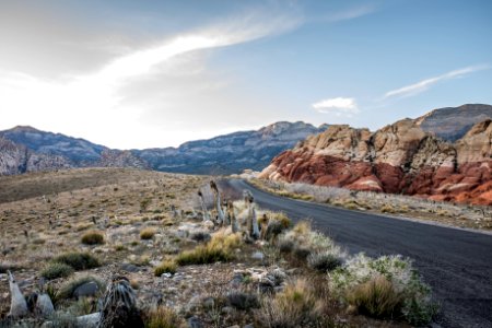 black concrete road surrounded by rocks during daytime photo