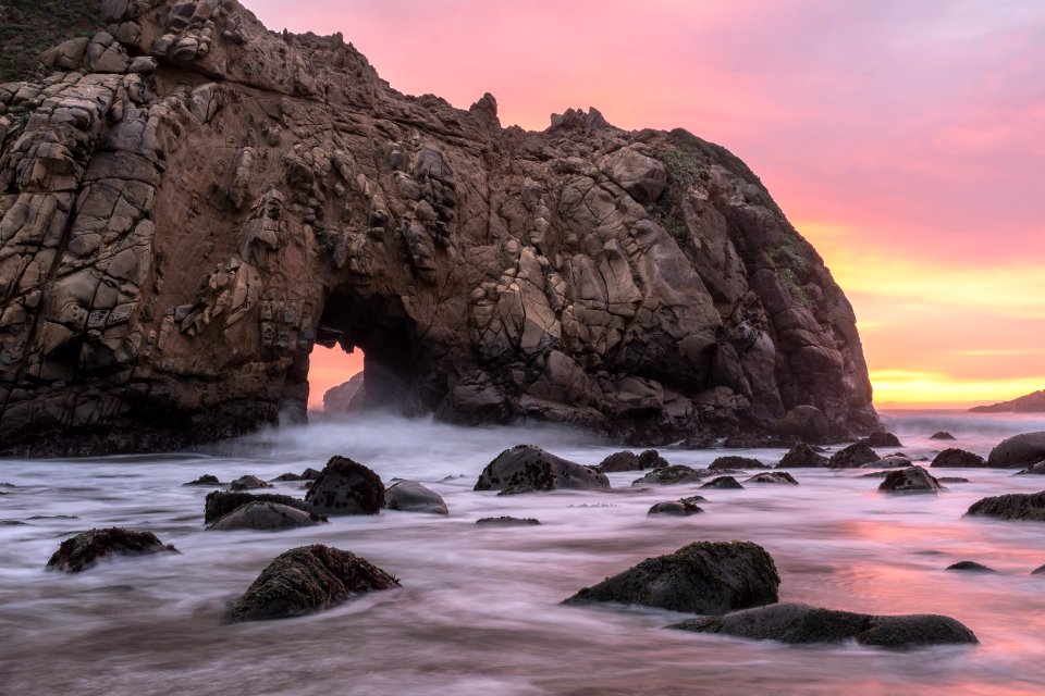 rocky ocean near tunnel
