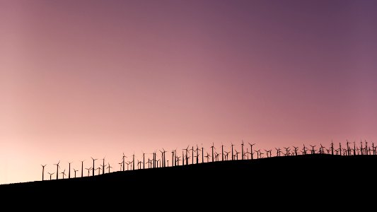 silhouette of wind turbines during daytime photo