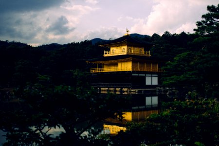 yellow and black pagoda near body of water photo