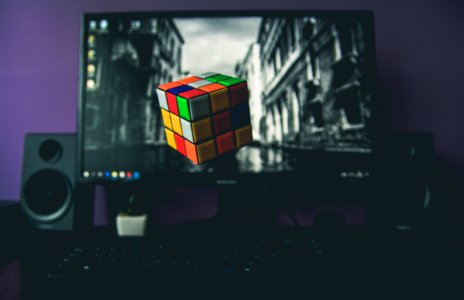 turned on flat screen computer monitor displaying 3x3 Rubik's cube photo