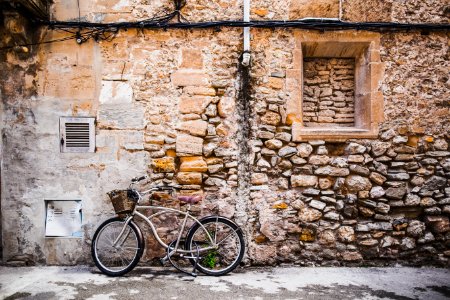 bicycle leaning on wall photo