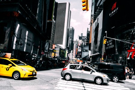 cars on road between high rise buildings during daytime photo