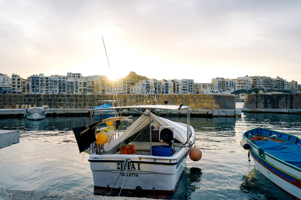 white and blue boat on water during daytime photo