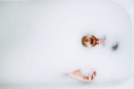 person on bath tub showing beard photo