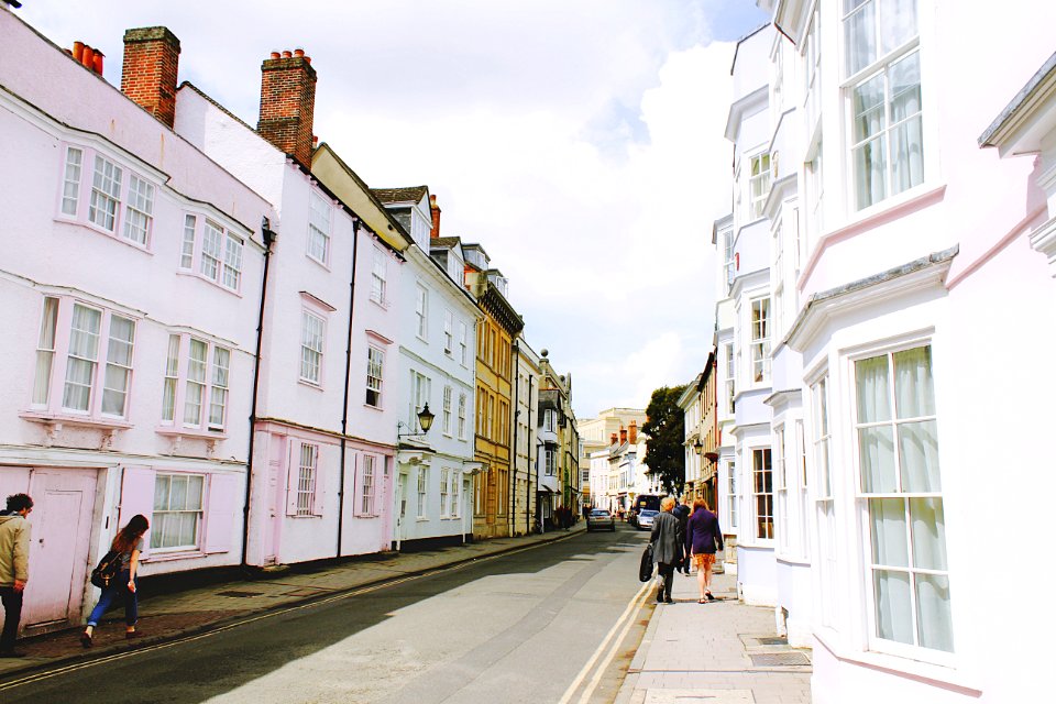 people walking on sidewalk beside building and road