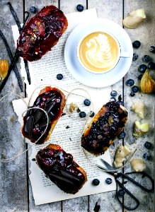fruit cakes, cappuccino and blueberries on gray wooden panel photo
