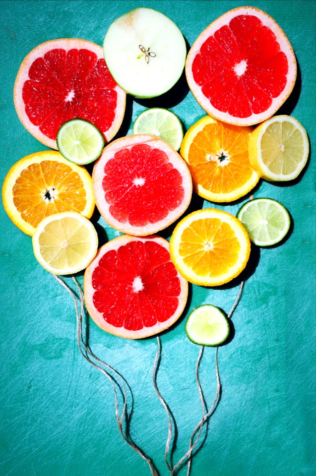 assorted fruit slices decor on teal surface