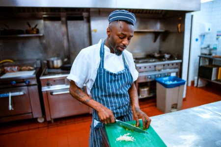 man chopping garlic gloves photo