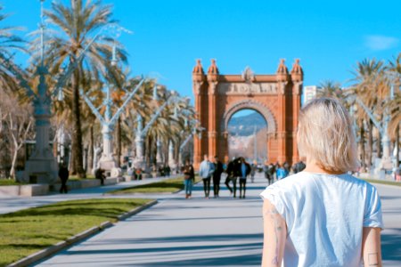 woman standing on road near concrete arch at daytime photo