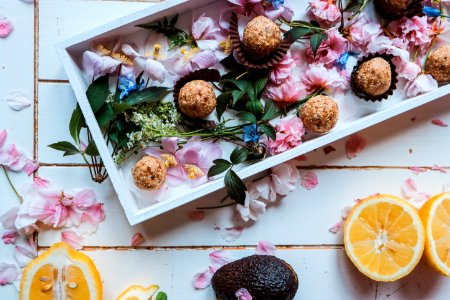 sliced oranges beside plate of round pastries photo