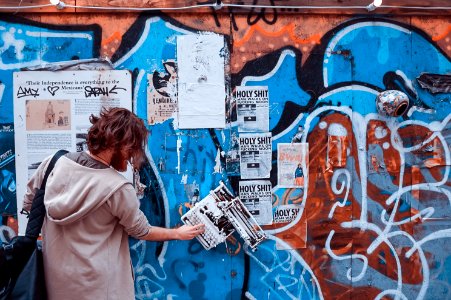 person in gray hoodie holding poster