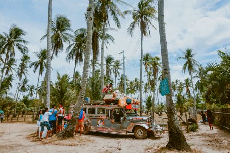 man on top of jeepny photo