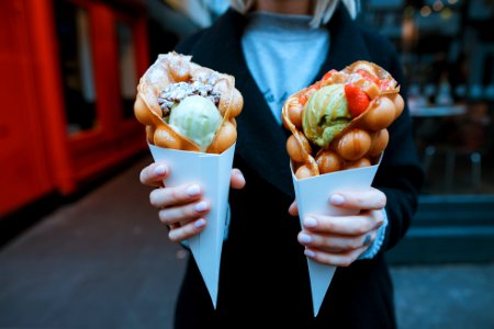 person holding two ice creams photo
