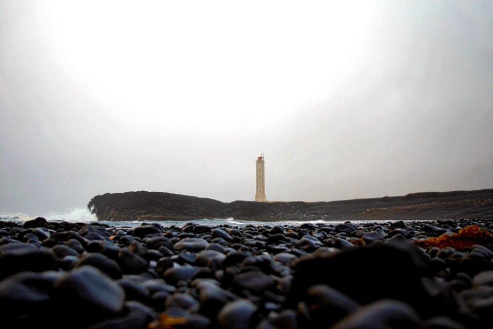 brown and white tower on the beach during daytime