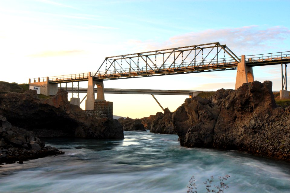 brown bridge over blue sea under blue sky during daytime