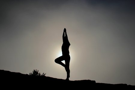 person doing yoga exercises photo
