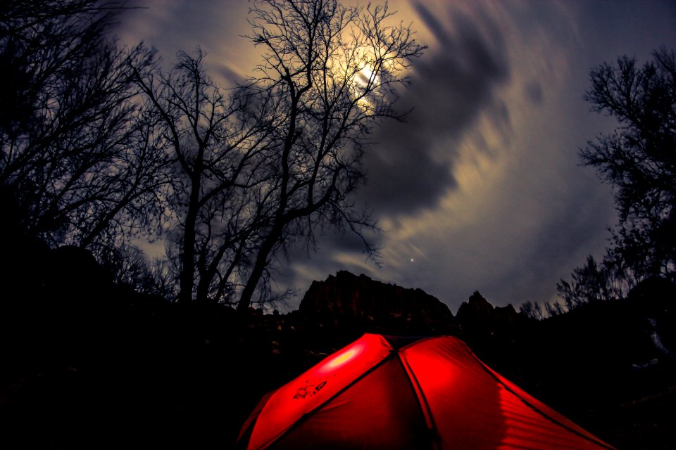 red tent on brown field under gray clouds