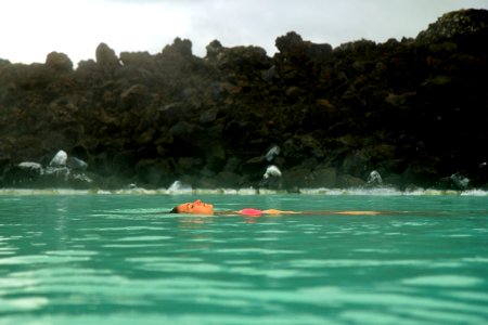 people swimming in the lake during daytime photo