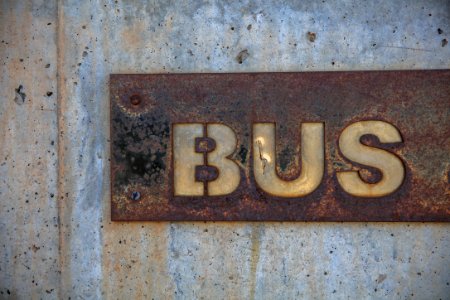 brown bus signage installed on wall photo