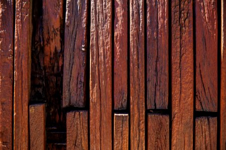 brown wooden board with black metal fence