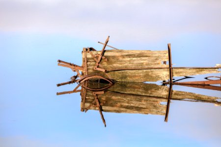 brown wooden ship wheel under blue sky during daytime photo